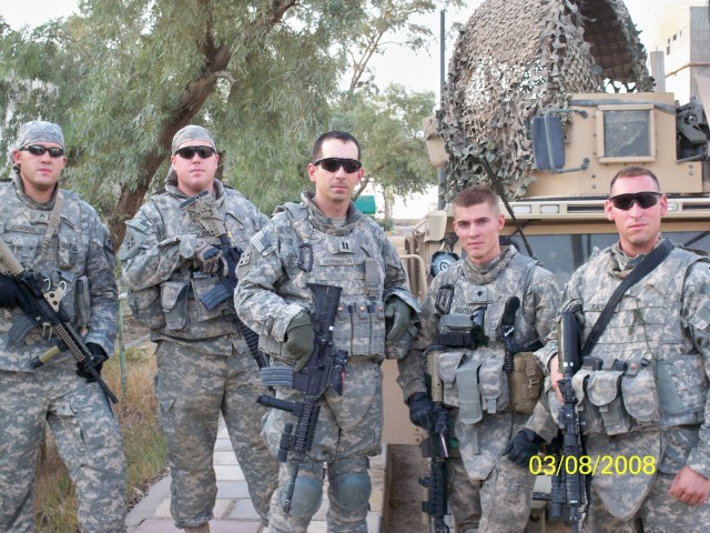 Capt. Brent Harrington (center) stands with his team in Majar al Kabir area of southern Iraq in 2008. Harrington was presented a Joint Commander's Commendation from the British Army at the 1st Cavalry Division Museum Oct. 28 at Fort Hood, Texas....