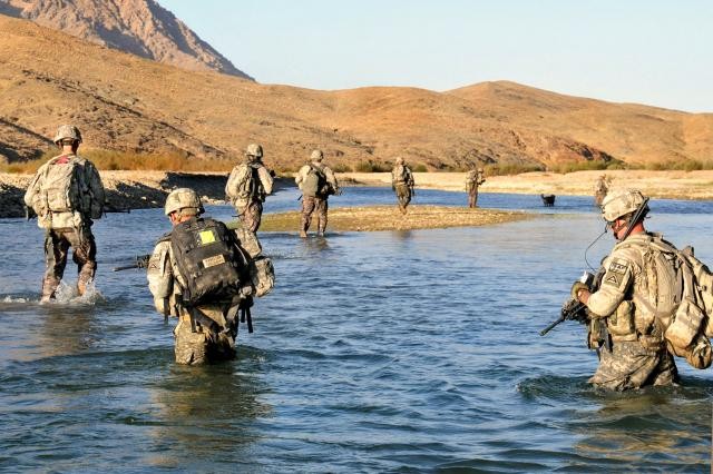 Soldiers cross a river to assist Afghan police on a humanitarian mission.