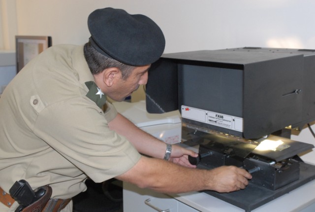 First Lieutenant Nazar Ihsan Chicho, an investigative officer at the Criminal Forensics Lab in Erbil, shows how to test for counterfeit bills during a tour of the facility for a group of 18 judges and lawyers Oct, 27. The goal of this tour was to...