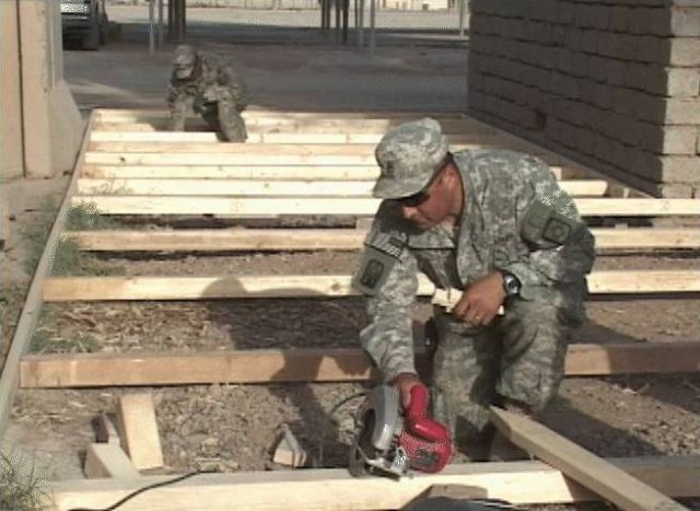 Staff Sgt. Migeul Padilla, the maintenance noncommissioned officer with the 515th Combat Sustainment Support Battalion out of Rio Grande, N.M., and a Rio Rancho, N.M., native, uses a saw to cut wood for the Bataan Memorial Park deck at Contingency Op...