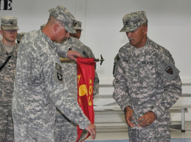 Capt. Daniel Schilleci, the 163rd Ordnance Detachment commander and Sherman Oaks, Calif., native, and Sgt. 1st Class Joseph Padilla, the detachment noncommissioned officer in charge and Tampa, Fla., native, uncase the detachment's guidon during a...