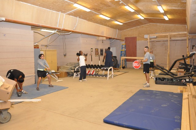 Soldiers and civilian employees of Headquarters and Headquarters, 15th Special Troops Battalion, 15th Sustainment Brigade, work out in the company's new CrossFit Gym here, Oct. 28. (U.S. Army photo by Sgt. Matthew C. Cooley, 15th Sustainment...