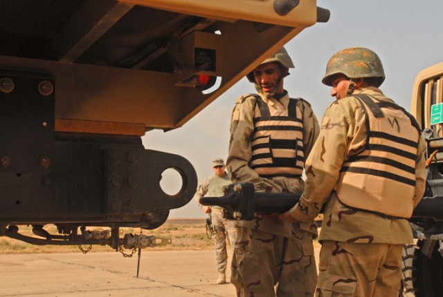 Iraqi Army Soldiers in the 12th MTR, 12th IAD, prepare to connect two vehicles during a truck rodeo competition at K-1 Military Base in Kirkuk, Nov. 1. These Soldiers, after attaching the vehicles, had to pull the truck forward in a safe manner to sh...