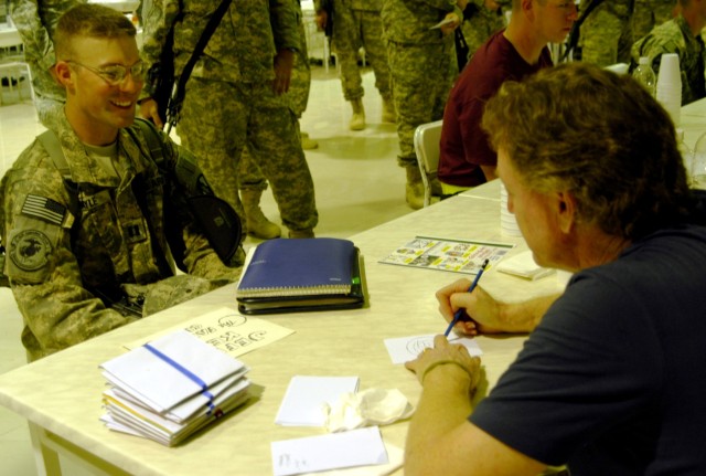 CONTINGENCY OPERATING LOCATION Q-WEST, Iraq - Capt. Bob Sayle, Q-West safety officer, 2nd Battalion,198th Combined Arms, and native of Lake Cormorant, Miss., chats with Jeff Keane, who draws "The Family Circus," which his father Bill Keane created. K...