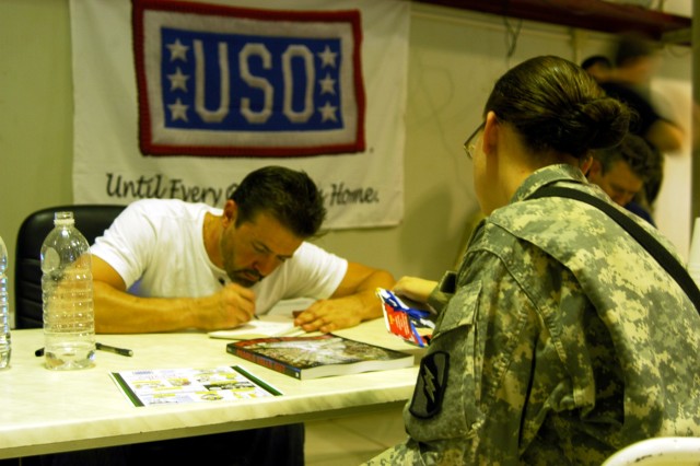 CONTINGENCY OPERATING LOCATION Q-WEST, Iraq - Stephan Pastis, creator of "Pearls Before Swine," draws for Pfc. Virginia N. Ward, Help Desk assistant for the Mayor Cell, 2nd Battalion, 198th Combined Arms out of Senatobia, Miss. Pastis was among...