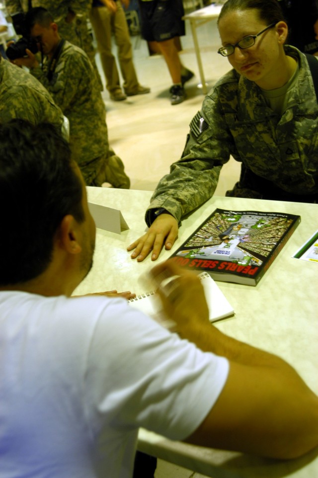 CONTINGENCY OPERATING LOCATION Q-WEST, Iraq - Pfc. Virginia N. Ward, Help Desk assistant for the Mayor Cell, 2nd Battalion, 198th Combined Arms out of Senatobia, Miss., chats with Stephan Pastis, creator of "Pearls Before Swine," as he draws her a ca...