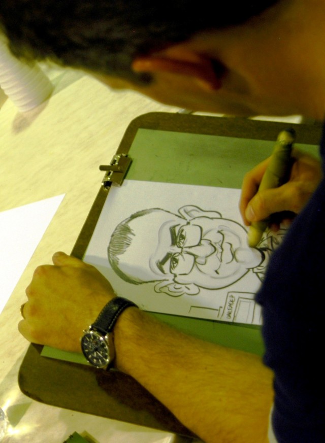 CONTINGENCY OPERATING LOCATION Q-WEST, Iraq - Satirical cartoonist Tom Richmond, Mad Magazine, draws a caricature of a Soldier during a visit here Oct. 20. Richmond was among five popular cartoonists and caricaturists who entertained troops at the...