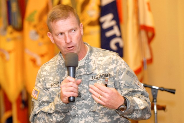 Sgt. Maj. of the Army Kenneth O. Preston speaks during a Noncommissioned Officer Symposium at Fort Irwin at Sandy Basin Community Center Oct. 27. He spoke to an audience of mostly NCO's and stressed to them that their role as teachers is integral...