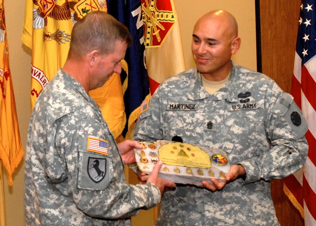 Fort Irwin and National Training Center Command Sgt. Maj. Victor Martinez presents Sgt. Maj. of the Army Kenneth O. Preston with a keepsake from the NTC as a gesture of appreciation. The Army's senior enlisted man closed out a Noncommissioned...