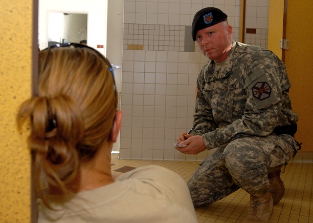 Pfc. Steven Chiaravalle, a military police officer with the Fort Irwin U.S. Army Garrison Military Police Company, interviews a "victim" of a sexual assault during a training event Oct. 24 of Fort Irwin. The victim was portrayed by Deputy Amy...