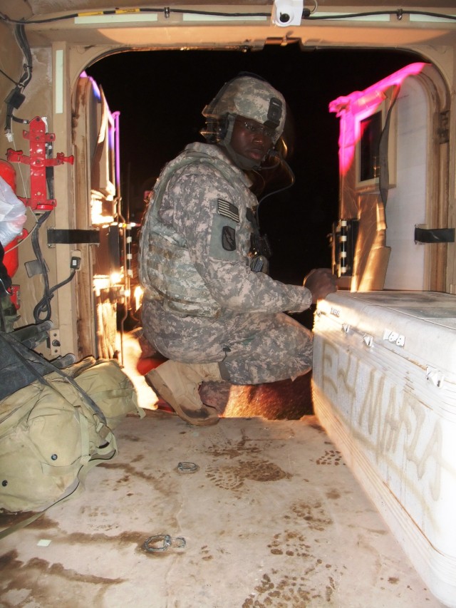 CONTINGENCY OPERATING LOCATION Q-WEST, Iraq - Spc. Corderal Fane, a Tallahatchie, Miss., native and gunner with 1st Platoon, C Company, 2nd Battalion, 198th Combined Arms out of Oxford, Miss., makes room in the storage area of his Caiman version of t...