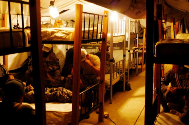 CONTINGENCY OPERATING LOCATION Q-WEST, Iraq - Members of 1st Platoon, C Company, 2nd Battalion, 198th Combined Arms, a Mississippi Army National Guard armor unit out of Oxford, Miss., relax in a temporary lodging tent at the Convoy Readiness Center, ...