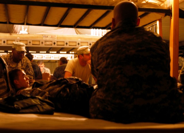CONTINGENCY OPERATING LOCATION Q-WEST, Iraq - Members of 1st Platoon, C Company, 2nd Battalion, 198th Combined Arms, a Mississippi Army National Guard armor unit out of Oxford, Miss., relax in a temporary lodging tent at the Convoy Readiness Center, ...
