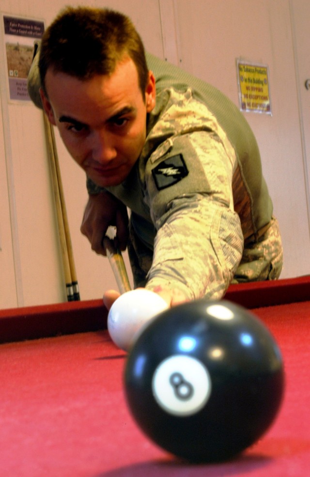 CONTINGENCY OPERATING LOCATION Q-WEST, Iraq - Spc. Jesse A. Jenkins, a native of Bruce, Miss., and driver with 1st Platoon, C Company, 2nd Battalion, 198th Combined Arms, a Mississippi Army National Guard armor unit out of Oxford, Miss., plays a pool...