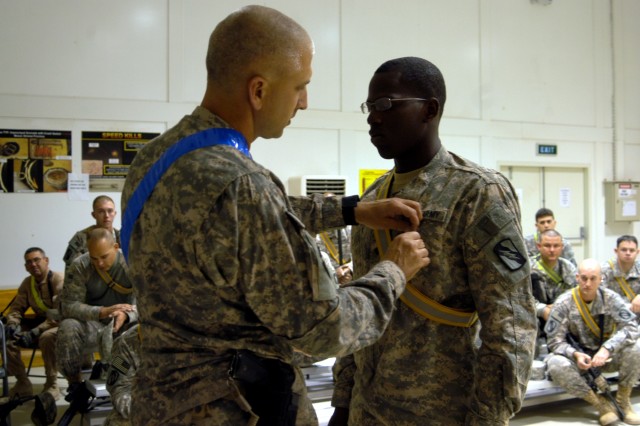 CONTINGENCY OPERATING LOCATION Q-WEST, Iraq - Lt. Col. Kerry Goodman (left), a Hattiesburg, Miss., native and commander of 2nd Battalion, 198th Combined Arms headquartered in Senatobia, Miss., pins an Army Achievement Medal on Spc. Corderal Fane, a T...
