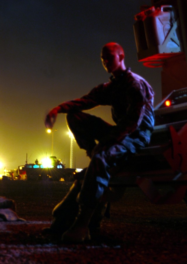 CONTINGENCY OPERATING LOCATION Q-WEST, Iraq - Spc. Jonathan A. Johnson, a gun truck driver with 1st Platoon, C Company, 2nd Battalion, 198th Combined Arms, an armor unit from Oxford, Miss., sits on the rear steps of his MaxxPro Mine-Resistant, Ambush...