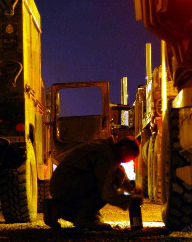 CONTINGENCY OPERATING LOCATION Q-WEST, Iraq - Sgt. Travis Carne, a turret gunner with 1st Platoon, C Company, 2nd Battalion, 198th Combined Arms, an armor unit from Oxford, Miss., checks a fire extinguisher in the COL Q-West Convoy Readiness Center y...