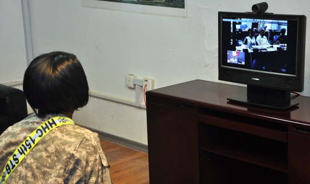 Capt. Nicole Harrell, a 15th Sustainment Brigade support operations planner and Los Angeles, native, speaks with her family at Fort Hood from the 15th Special Troops Battalion, 15th Sust. Bde., headquarters building here Nov. 7, two days after a...