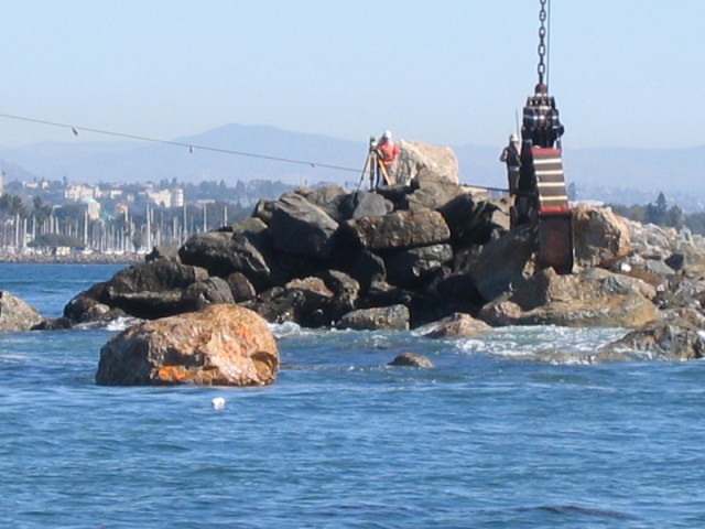 Crane moves 24-ton rock for jetty repair
