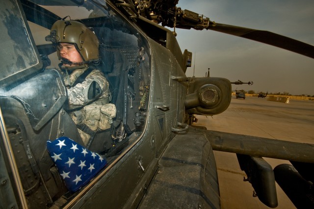 Capt. Lucas Kennedy, from Kearney, Neb., gets ready to fly on a mission over Baghdad, Iraq, Nov. 6. To show appreciation for the numerous items sent from a company out of Austin, Texas, he'll fly an American flag during the mission and later mail it ...