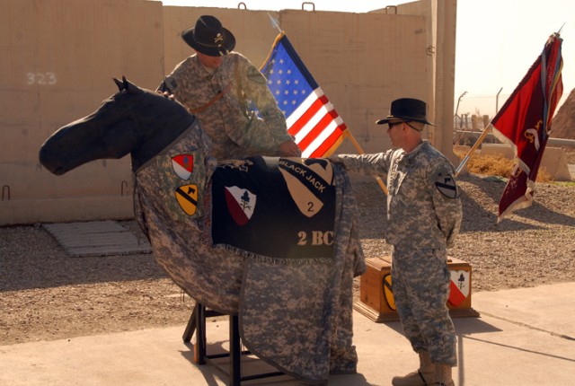 Lieutenant Colonel Chris Whittaker, the commander of the 15th Brigade Support Battalion, 2nd Brigade Combat Team, 1st Cavalry Division, climbs on top of a custom-made "horse" during a ceremony on Forward Operating Base Warrior, Kirkuk, Iraq, Nov....