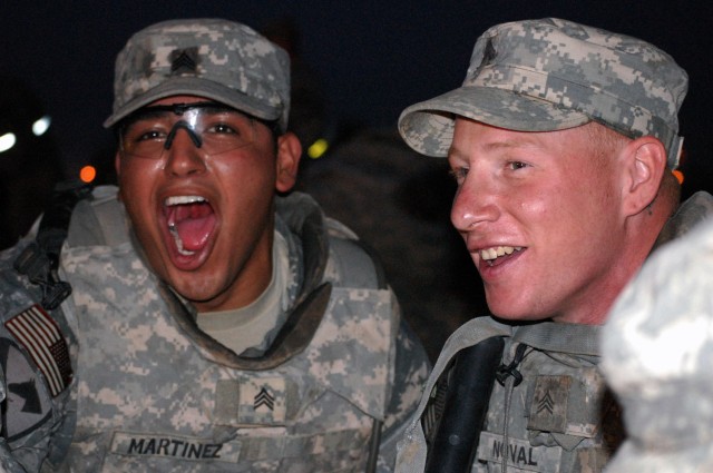 CAMP TAJI, Iraq -Los Angeles, Calif. native Sgt. Jose Martinez (left), and Sgt. John Noval, both assigned to 1st Battalion, 82nd Field Artillery Regiment, 1st Brigade Combat Team, 1st Cavalry Division, sing the Army Song during a "Spur Ride" on Camp ...