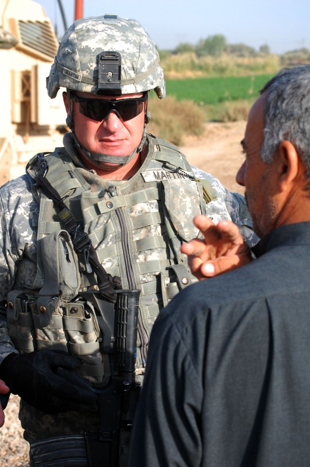 TAJI, Iraq - Mt. Holly, N.C. native, Sgt. 1st Class Gregory Martin, attached to the 1st Brigade Combat Team, 1st Cavalry Division, speaks to local leader Sheik Abdullah during a final inspection of a bridge with his namesake in Taji, Nov. 10. The...