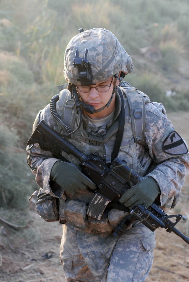 BAGHDAD-Chincoteague Island, Va. native, Pfc. David Hill, with 1st Battalion, 5th Cavalry Regiment, walks through Tarmiyah during a combined cordon and knock, Nov. 11.  The joint American and Iraqi patrol conducted the search to ensure the security o...