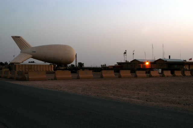 CONTINGENCY OPERATING LOCATION Q-WEST, Iraq - The 17-meter Aerostat of Contingency Operating Location Q-West secured to its mobile mooring station, awaiting an evening dust storm Oct. 12. The aerostat - maintained and operated by crewmembers from...