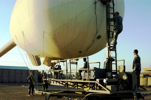 CONTINGENCY OPERATING LOCATION Q-WEST, Iraq - Crewmembers of Alpha Team take up their duty positions around the mobile mooring station of Q-West's 17-meter Aerostat during a hoisting operation Nov. 7. The aerostat crewmembers - all from A Company,...