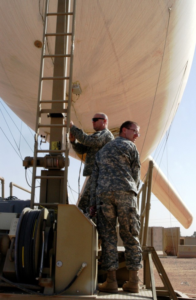 CONTINGENCY OPERATING LOCATION Q-WEST, Iraq - Sgt. Wesley G. Patrick (foreground), Bravo Team Leader of Q-West's 17-meter Aerostat and native of Southaven, Miss., and Joshua M. Jenkins, an aerostat crewmember from Hernando, Miss., stand beside the...