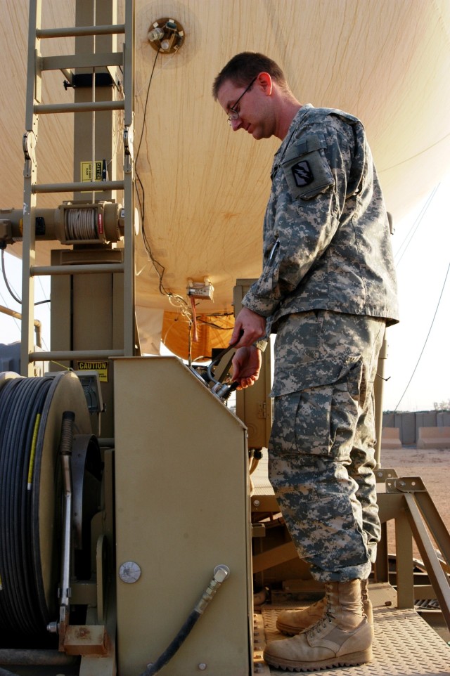 CONTINGENCY OPERATING LOCATION Q-WEST, Iraq - Sgt. Wesley G. Patrick, Bravo Team Leader of Q-West's 17-meter Aerostat and native of Southaven, Miss., mans the winch control panel as he and his team prepared to hoist the balloon Nov. 6. The...