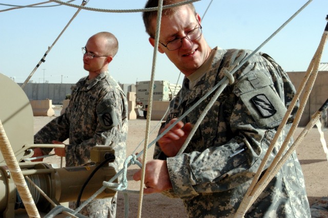 CONTINGENCY OPERATING LOCATION Q-WEST, Iraq - Sgt. Wesley G. Patrick (foreground), Bravo Team Leader of Q-West's 17-meter Aerostat and native of Southaven, Miss., and Spc. Steven F. Hahn, a crewmember from Memphis, Tenn., secure mooring lines to...