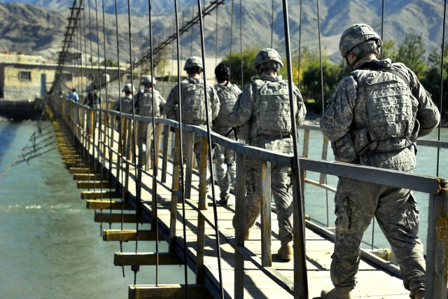 Soldiers cross bridge