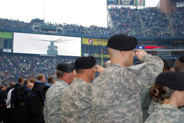 Soldiers from Fort Lewis present the proper honors to the National Anthem before the opening kickoff of the Detroit Lions-Seattle Seahawks game Nov. 8 at Qwest Field. Service members were treated to a 32-20 Seahawks win thanks to 'Hawks quarterback M...