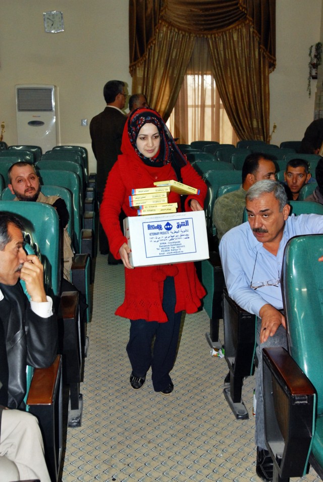 An Iraqi veterinarian carries recently acquired medical supplies to her vehicle at the Kirkuk Agricultural Department in Kirkuk, Iraq, Nov. 17. In an effort to improve veterinary services and increase agricultural production, representatives from...