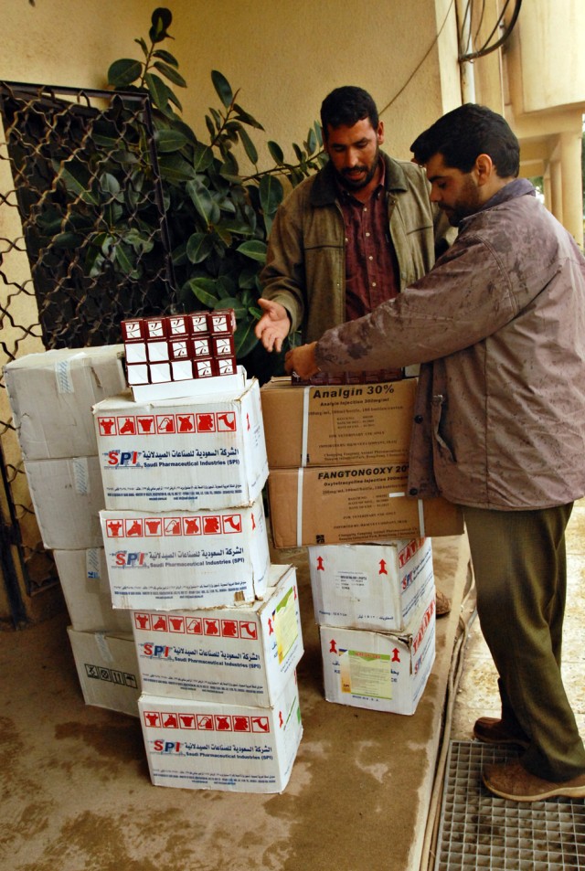 An Iraqi veterinarian carries recently acquired medical supplies to his vehicle at the Kirkuk Agricultural Department in Kirkuk, Iraq, Nov. 17. In an effort to improve veterinary services and increase agricultural production, representatives from...