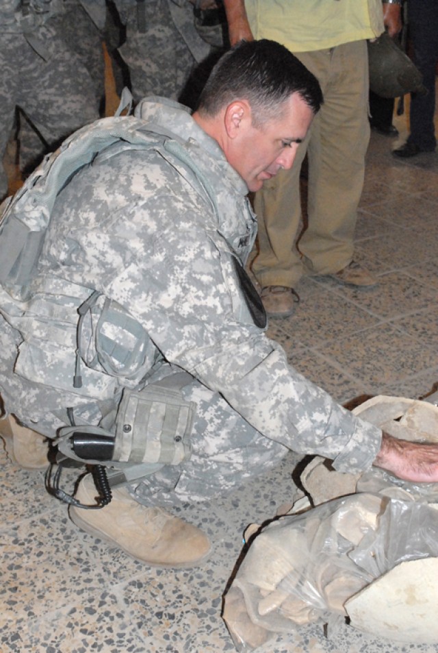 Lt. Col. Hugh McNeely, the deputy commanding officer of 2nd Brigade Combat Team, 1st Cavalry Division, examines some artifacts at the Kirkuk Museum in Kirkuk, Iraq, Nov. 16. McNeely lead a group of Soldiers in a visit to the museum, and then later...