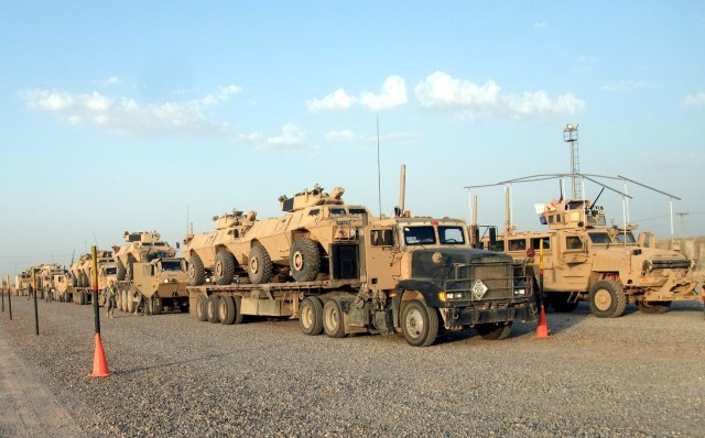 CONTINGENCY OPERATING LOCATION Q-WEST, Iraq - Loaded flatbeds of the 40th Transportation Company from Fort Lewis, Wash., and gun trucks from the Mississippi Army National Guard's A Co., 2nd Battalion, 198th Combined Arms, out of Hernando, Miss., awai...