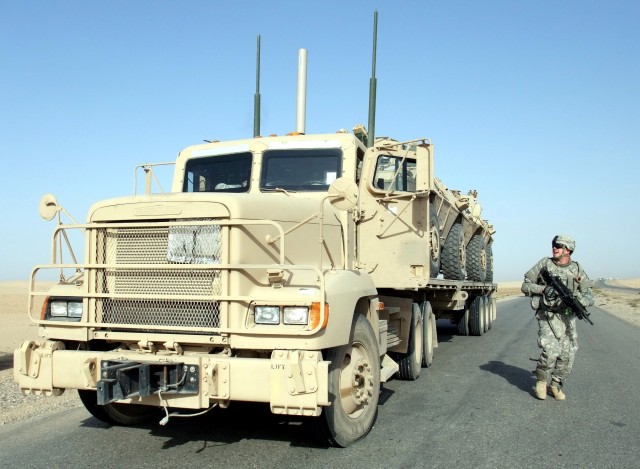 CONTINGENCY OPERATING LOCATION Q-WEST, Iraq - Pfc. Enrico Quezada, a native of Columbus, Ga., and member of the 40th Transportation Company, out of Fort Lewis, Wash., takes up a security position after the convoy halted during a Nov. 9 mission...