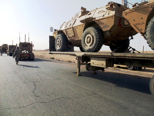 CONTINGENCY OPERATING LOCATION Q-WEST, Iraq - Soldiers with the 40th Transportation Company, out of Fort Lewis, Wash., and Guardsmen with A Company, 2nd Battalion, 198th Combined Arms, headquartered in Hernando, Miss., hurry to switch out an overheat...