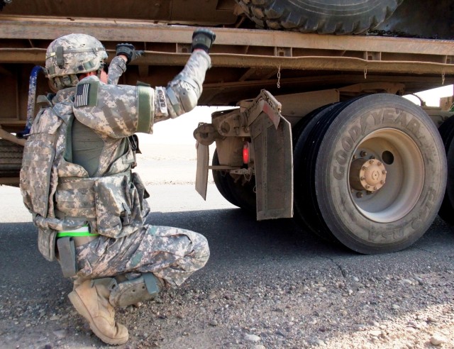 CONTINGENCY OPERATING LOCATION Q-WEST, Iraq - Pfc. Enrico Quezada, a native of Columbus, Ga., and member of the 40th Transportation Company, out of Fort Lewis, Wash., guides a semi-truck as it hooks up to a loaded trailer during a Nov. 9 mission from...