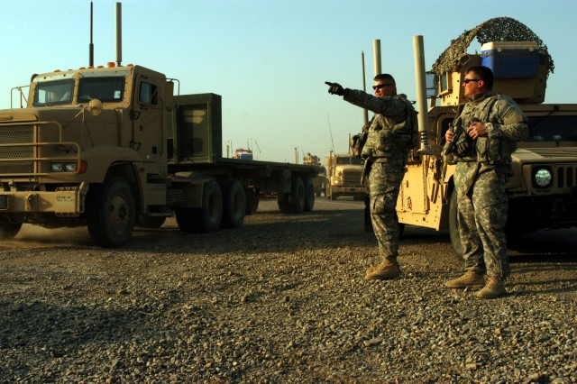 CONTINGENCY OPERATING LOCATION Q-WEST, Iraq -2nd Lt. Jeffery T. Watkins, a native of Biloxi, Miss., and Sgt. Brandon A. Craddock, Guardsmen with A Company, 2nd Battalion, 198th Combined Arms out of Hernando, Miss., direct trucks with the 40th Transpo...