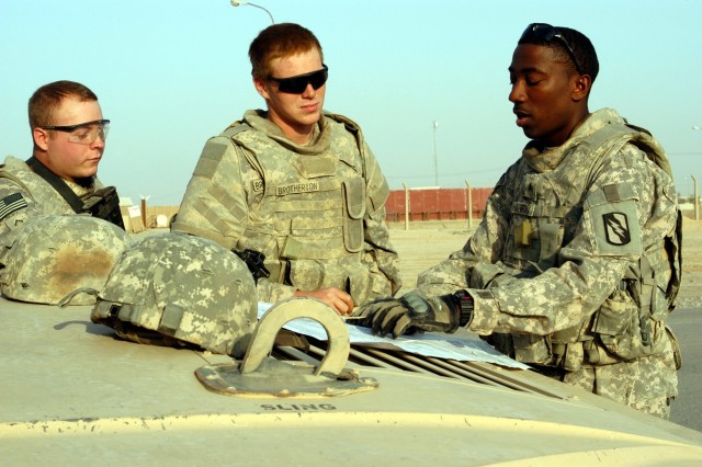 CONTINGENCY OPERATING LOCATION Q-WEST, Iraq - Pfc. David G. Justus, a driver from Southaven, Miss., and Spec. Jason R. Brotherton, a gunner from Byhalia, Miss., listen as Sgt. Dreamus Harron, a vehicle commander from Brookhaven, Miss., briefs them be...