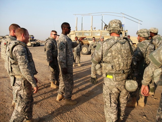 CONTINGENCY OPERATING LOCATION Q-WEST, Iraq - Staff Sgt. Kenwith Scott, convoy commander from Rosedale, Miss., briefs members of his convoy before leaving COB Speicher to return to Q-West during a Nov. 9 convoy mission. Scott is a member of A Company...