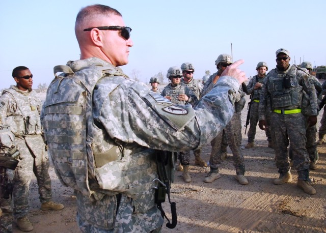 CONTINGENCY OPERATING LOCATION Q-WEST, Iraq - Capt. Drew Clark, a Madison, Miss., native and commander of  A Company, 2nd Battalion, 198th Combined Arms out of Hernando, Miss., gathers members of his convoy for a brief before leaving COB Speicher to ...