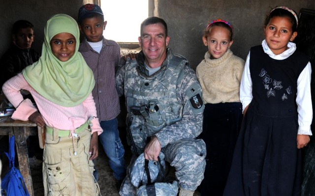 Soldiers deliver supplies, view new school building