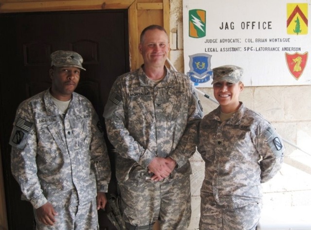 CONTINGENCY OPERATING LOCATION Q-WEST, Iraq - Spc. Latorrance Anderson (left) of Tunica, Miss., Col. Brian A. Montague, of Hattiesburg, Miss., and Spc. Tamaleilua Mose, of Chaney, Wash., in an Aug. 8 photo, standing in front of a newly painted sign f...