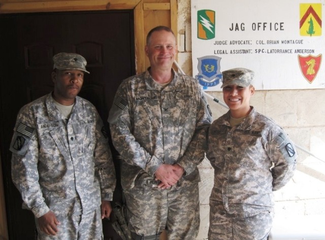 CONTINGENCY OPERATING LOCATION Q-WEST, Iraq - Spc. Latorrance Anderson (left) of Tunica, Miss., Col. Brian A. Montague, of Hattiesburg, Miss., and Spc. Tamaleilua Mose, of Chaney, Wash., in an Aug. 8 photo, standing in front of a newly painted...