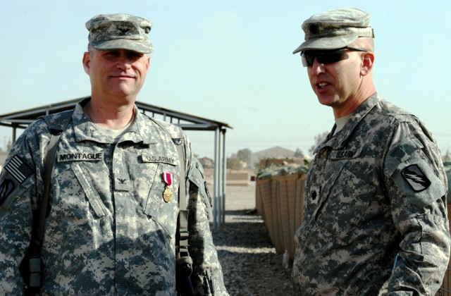 CONTINGENCY OPERATING LOCATION Q-WEST, Iraq - After being awarded a Meritorious Service Medal, Col. Brian A. Montague (left), a native of Hattiesburg, Miss., and command judge advocate for Mississippi's 2nd Battalion, 198th Combined Arms out of Senat...